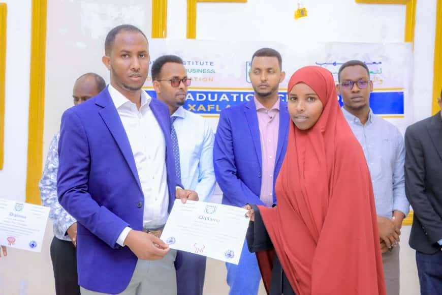SIHBA student receiving a graduation certificate